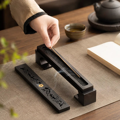 Hand holding an ebony incense box for elegant incense storage and aromatherapy use