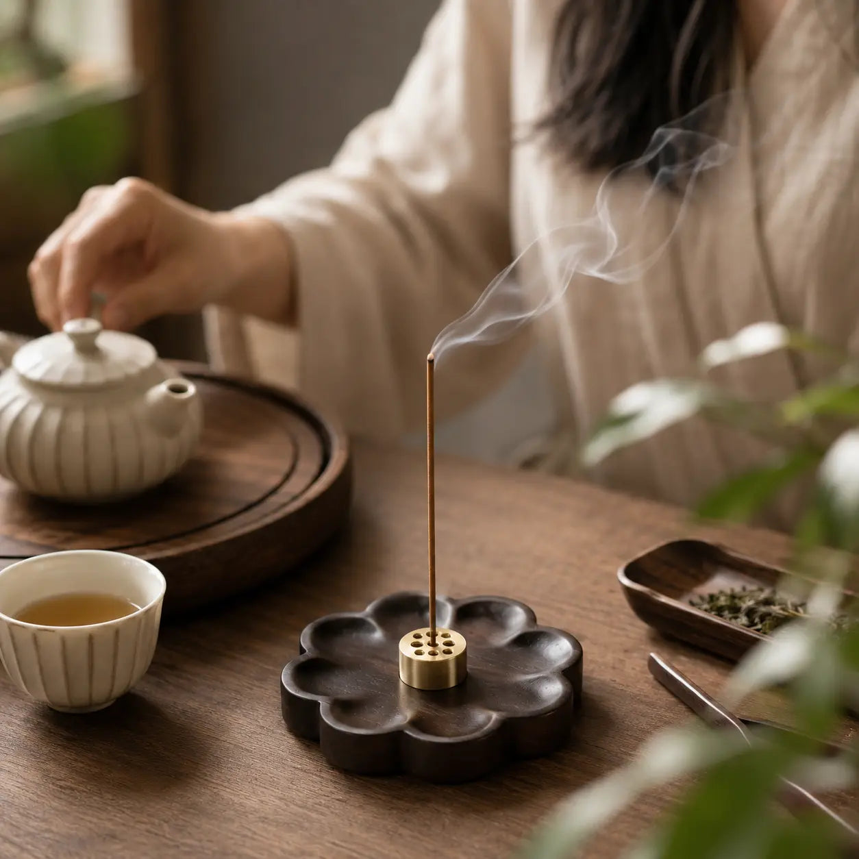 Sakura wood incense holder styled with natural elements for a peaceful scent experience