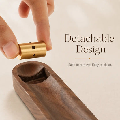 Close-up of a walnut and brass incense holder with a clean ash catching design